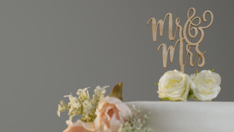 Close-Up-Of-Wedding-Cake-Against-Grey-Studio-Background-At-Wedding-Reception-2